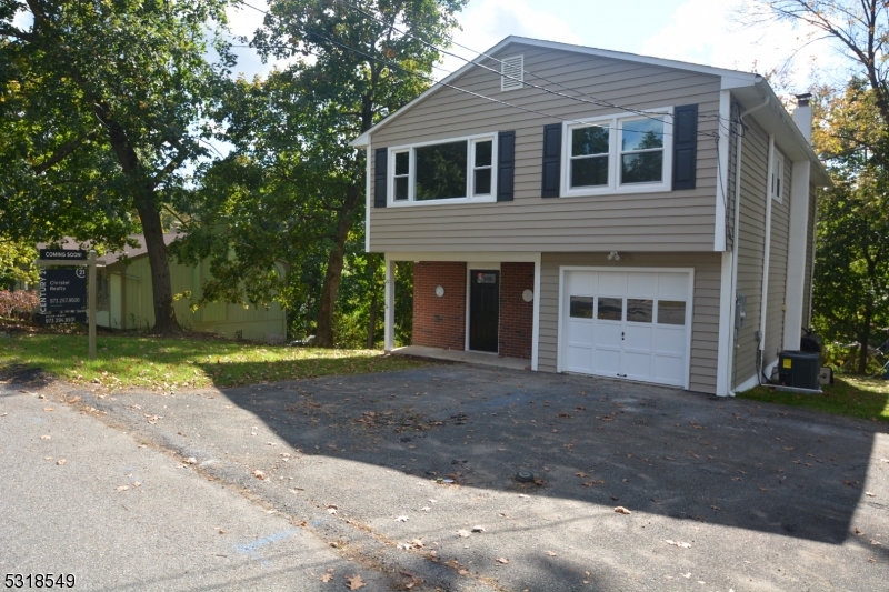 a front view of a house with a yard and a garage