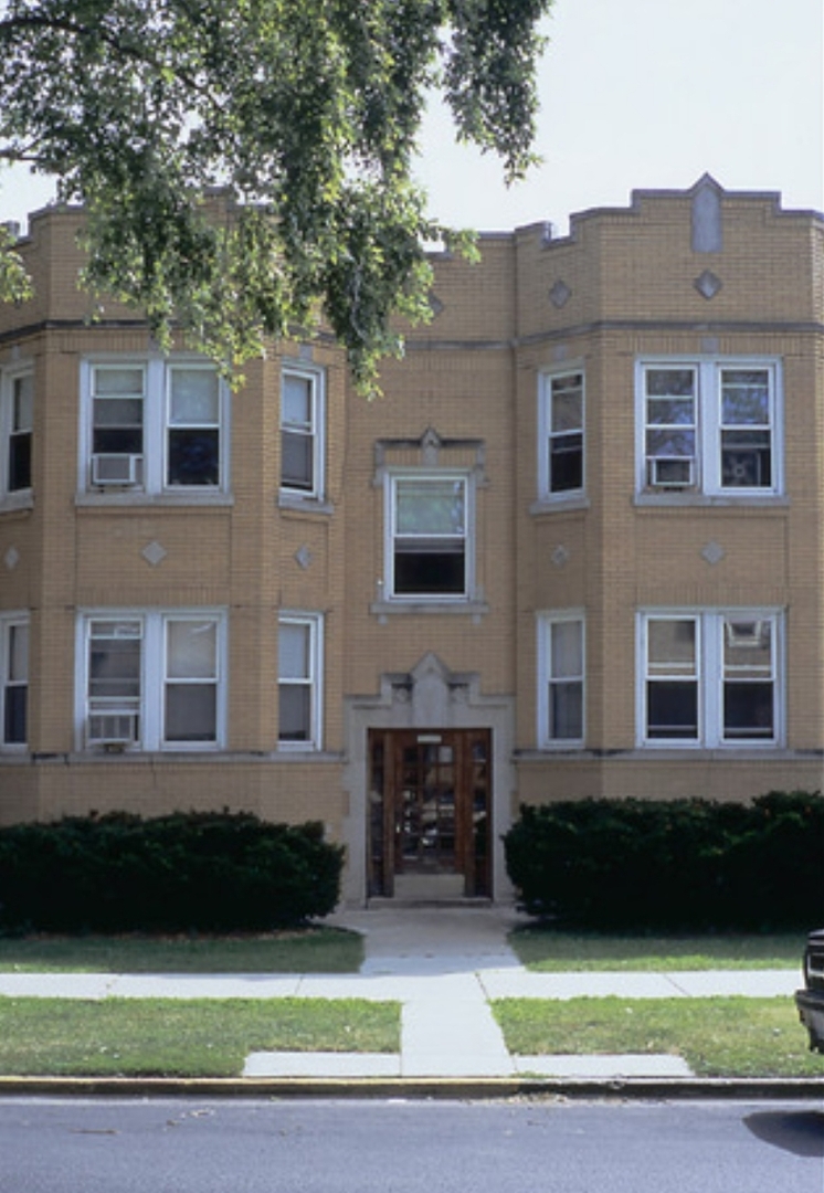 a front view of a house with yard and green space