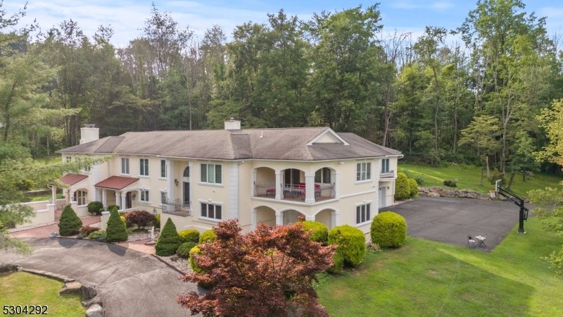 a aerial view of a house with a big yard plants and large trees