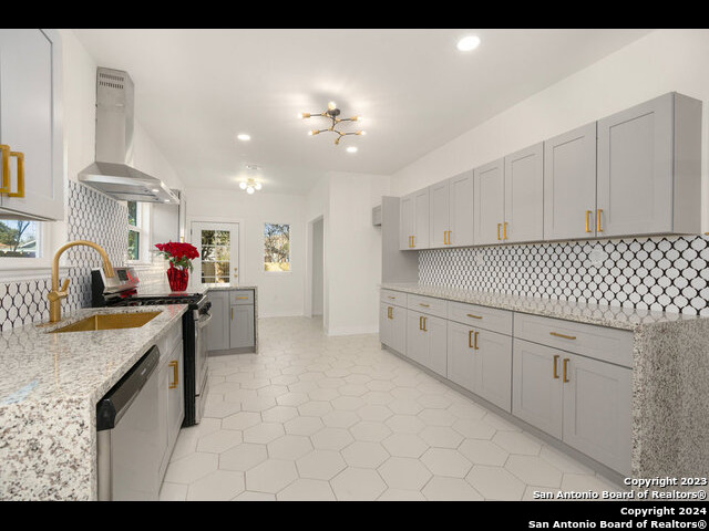 a kitchen with cabinets a sink and appliances