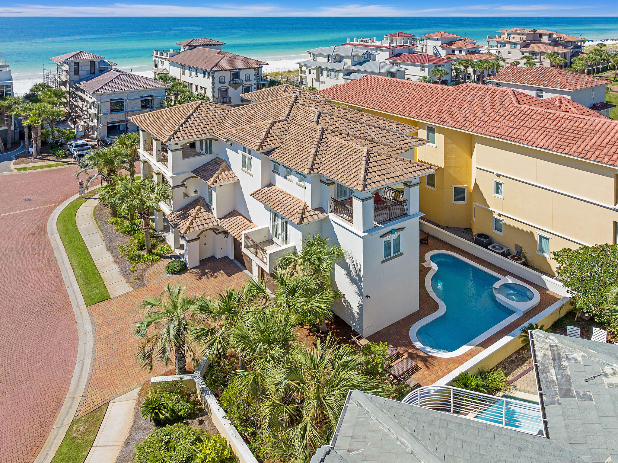 an aerial view of a house with a yard and lake view