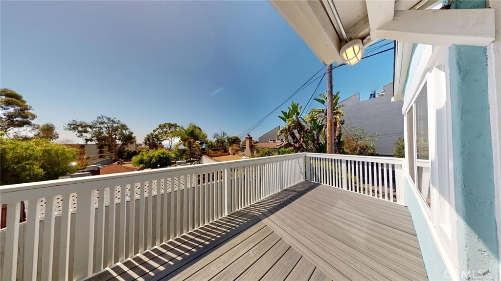 a view of a balcony with wooden floor