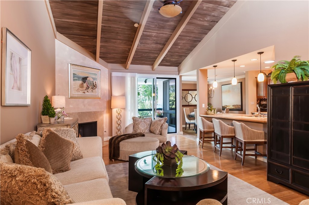 a living room with fireplace furniture and a large window