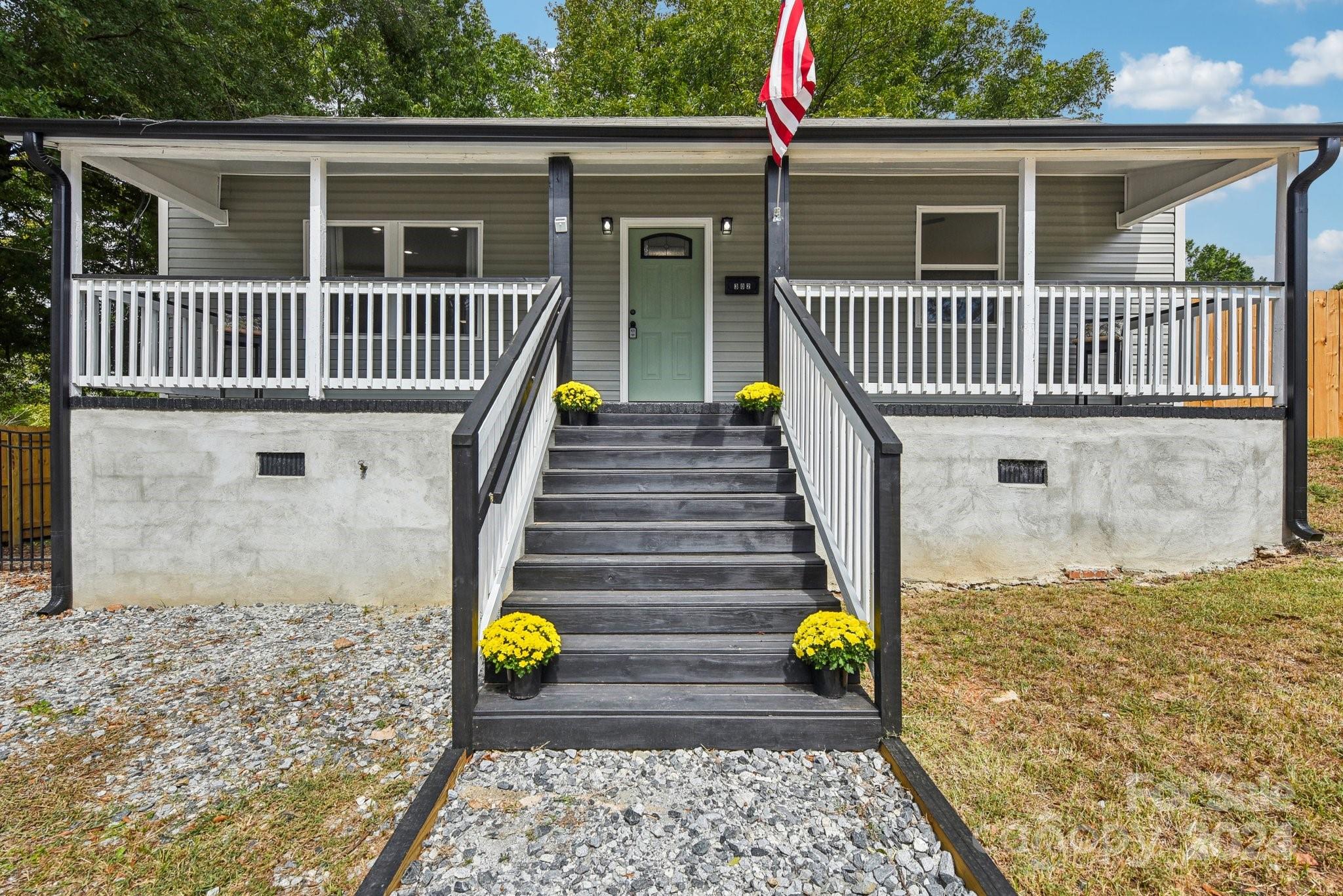 a view of house with backyard and outdoor seating