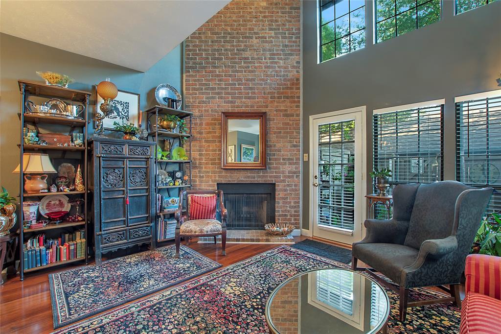 a living room with furniture a rug and a fireplace