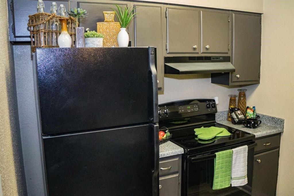 a kitchen with a stove and a refrigerator