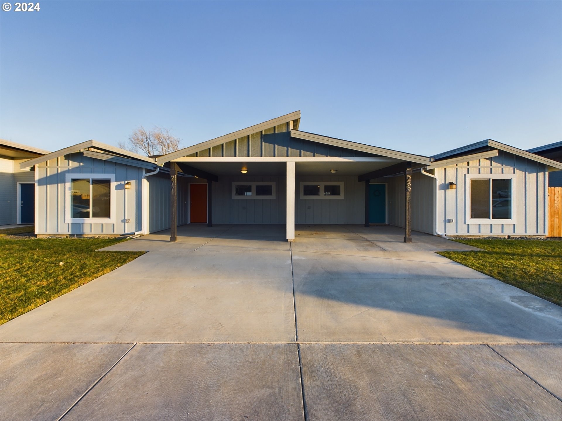 a front view of a house with a garage and yard