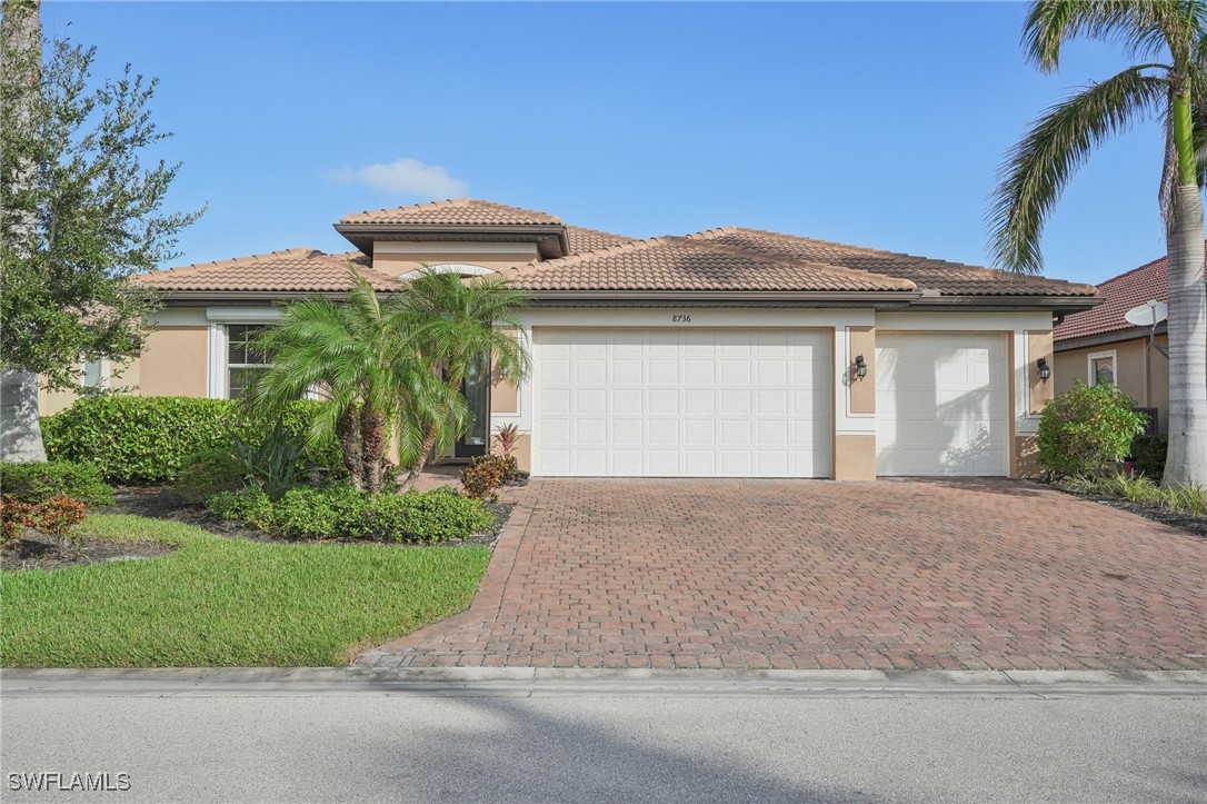 a front view of a house with a yard and garage