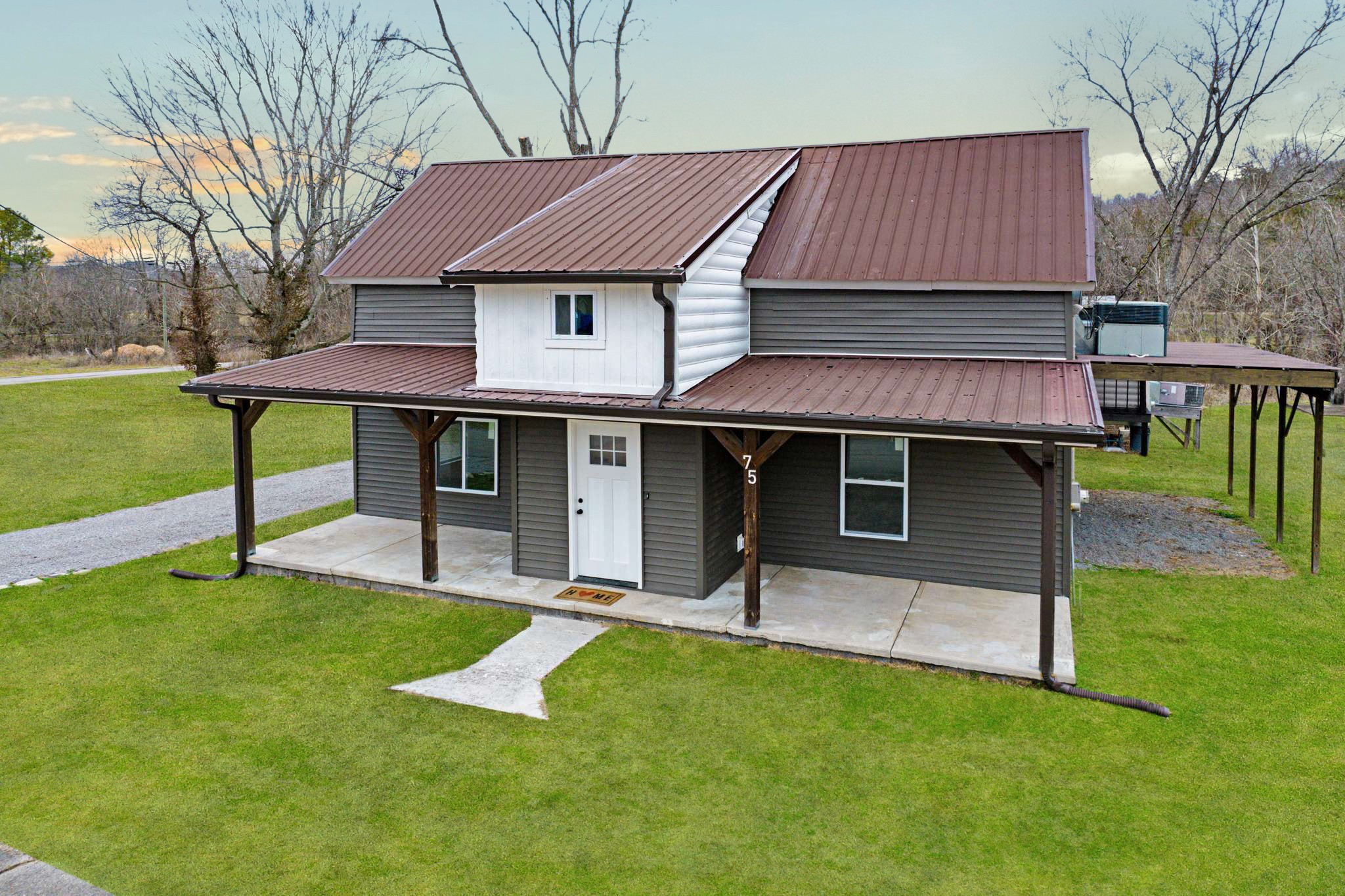 a front view of a house with a garden and yard