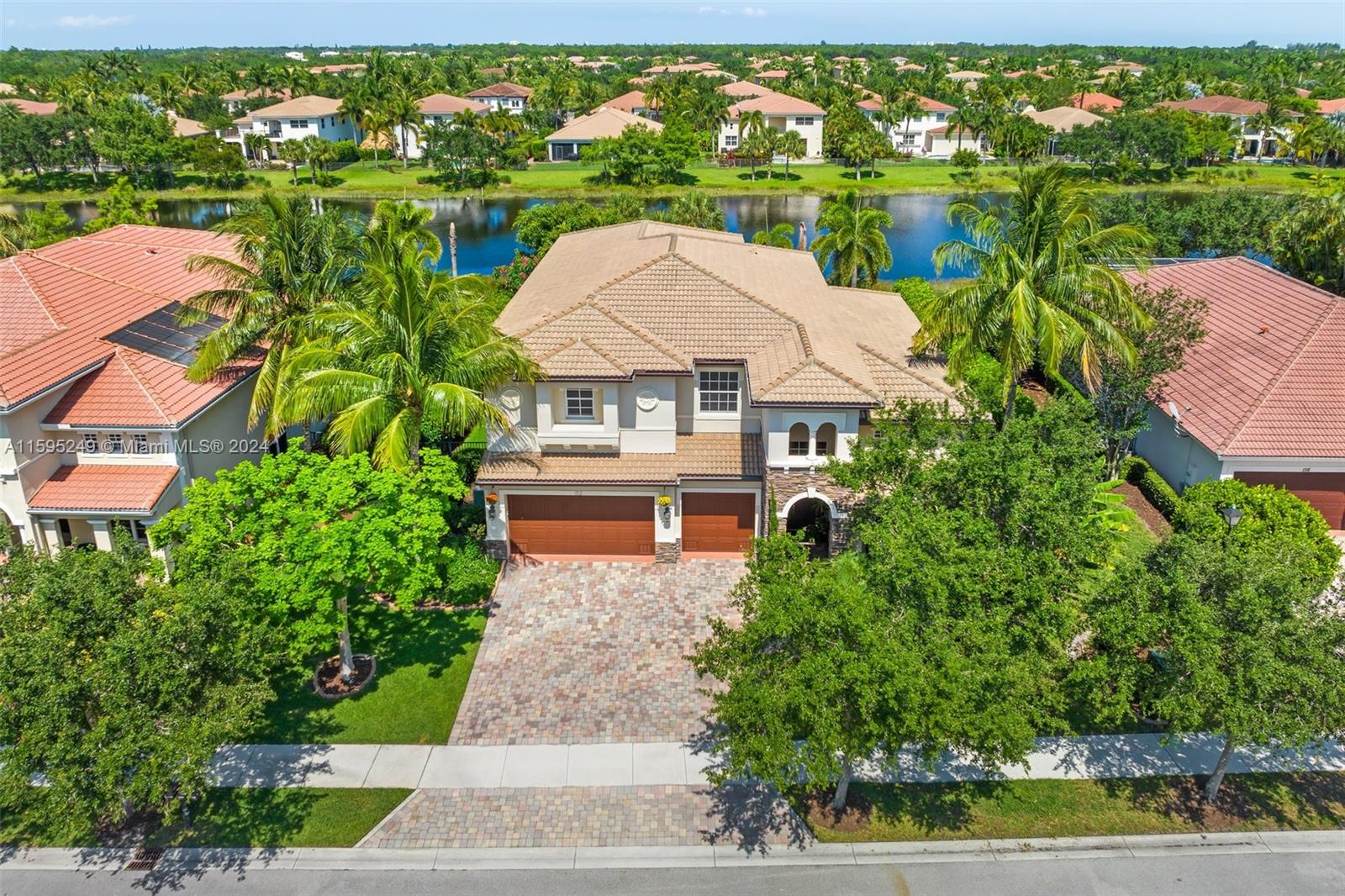 an aerial view of a house with yard lake and outdoor seating