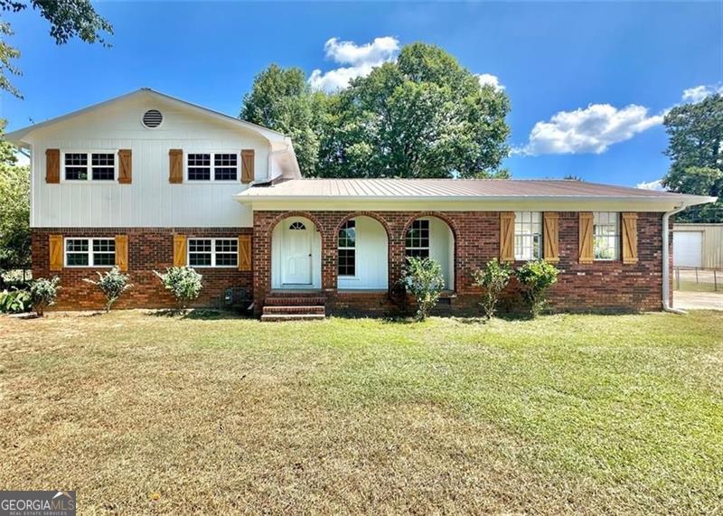 a front view of a house with a yard