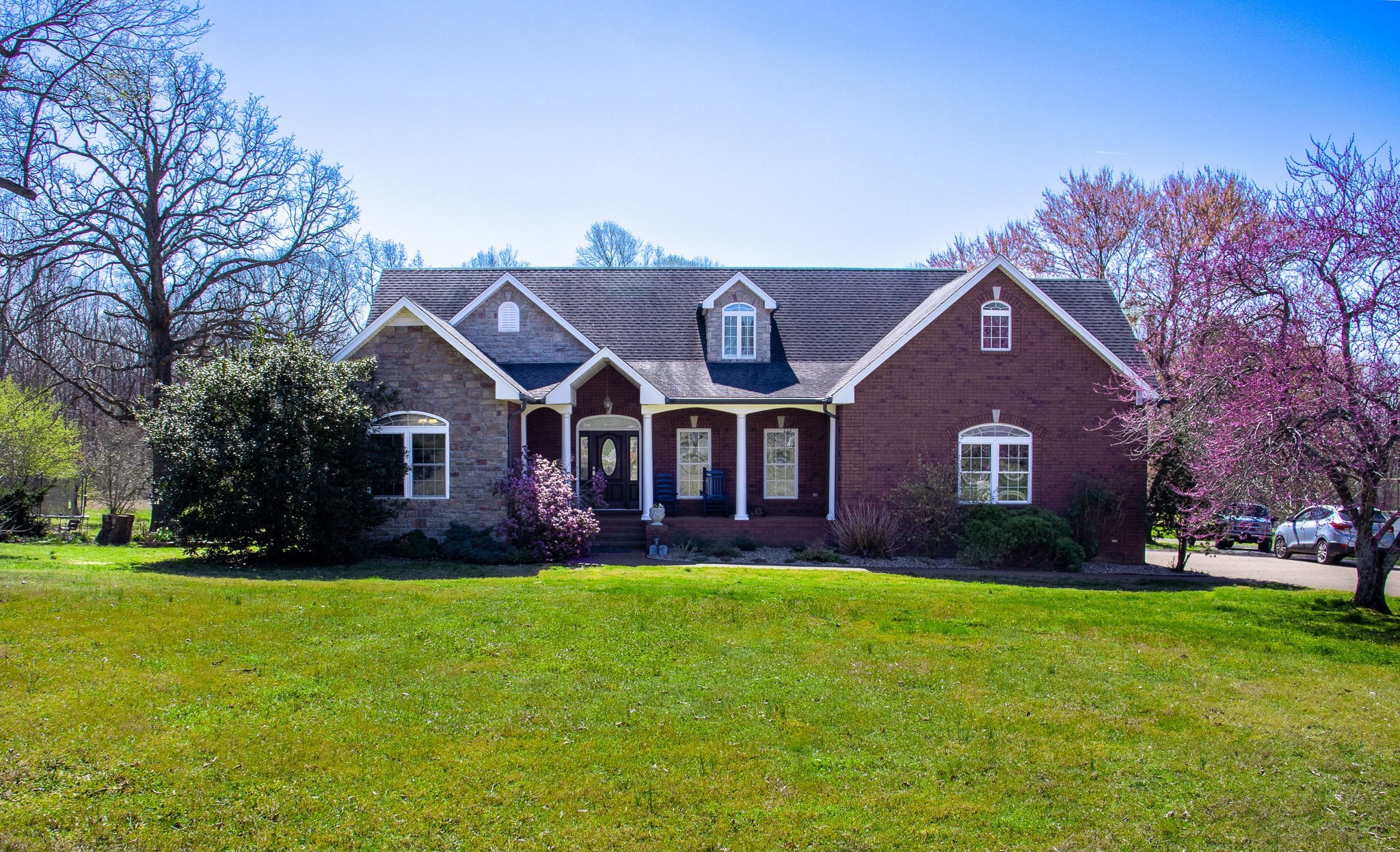 a front view of house with yard and green space