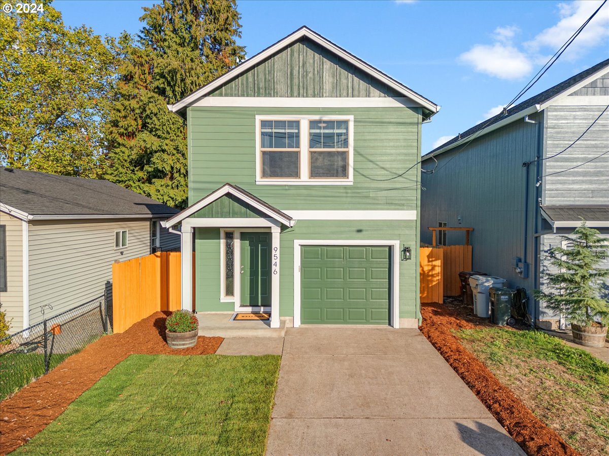 a front view of a house with yard and porch