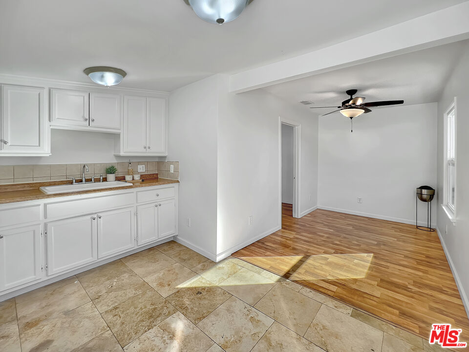 a view of a kitchen with sink cabinets and outdoor space