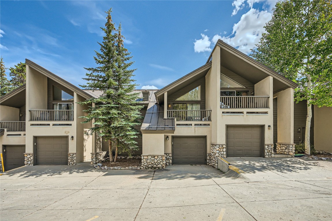 View of property featuring a balcony and a garage