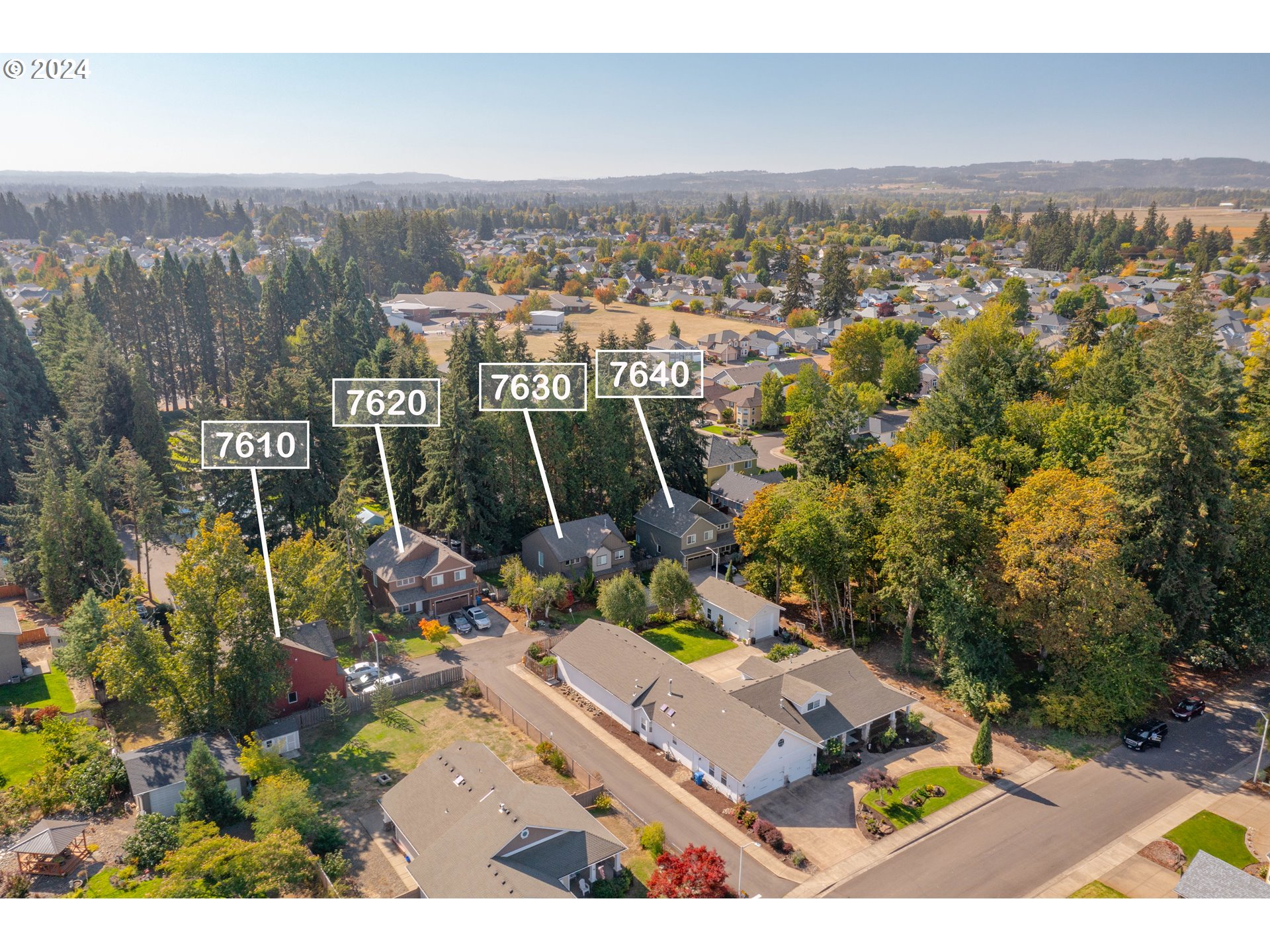 an aerial view of residential houses with outdoor space