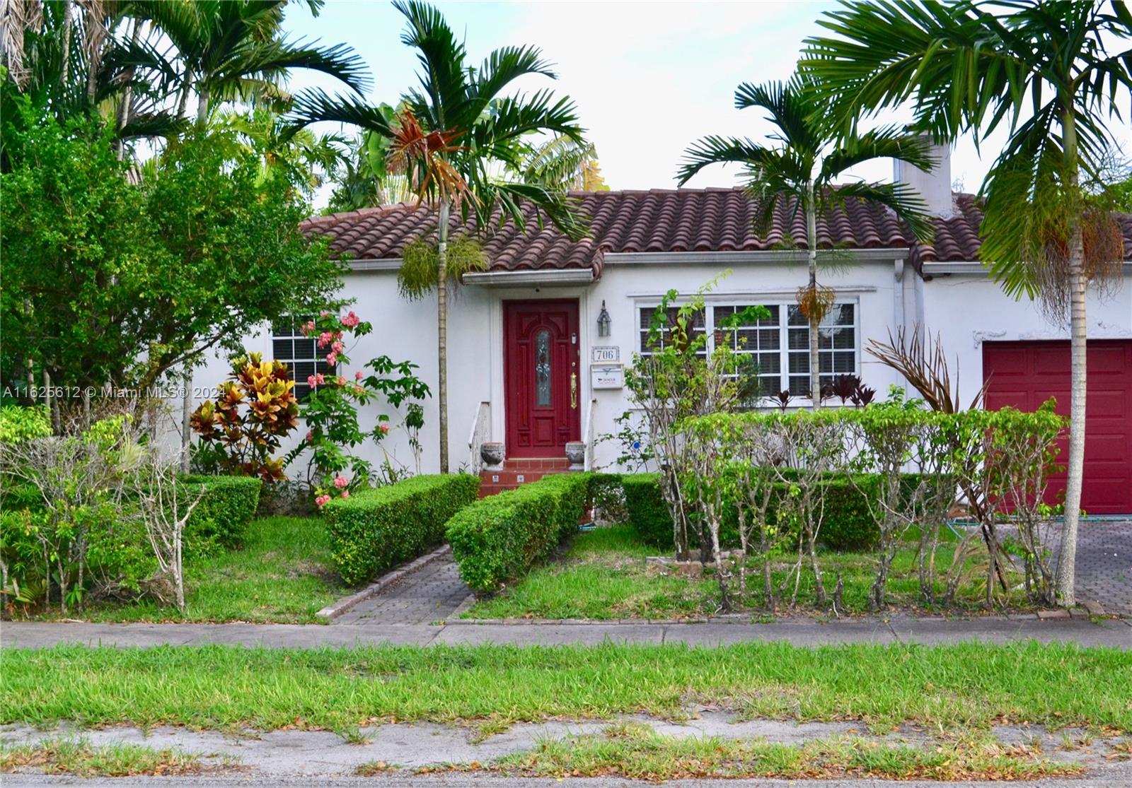 a front view of a house with a garden