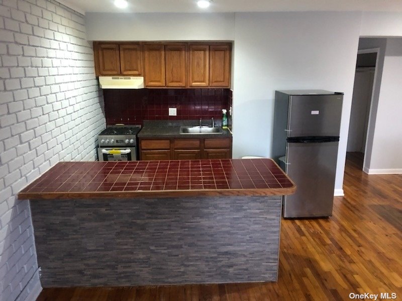 a view of kitchen island with cabinets