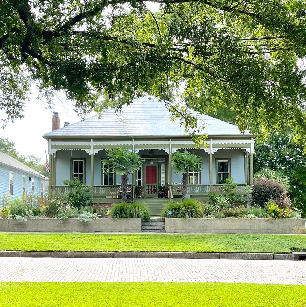 a front view of a house with a garden