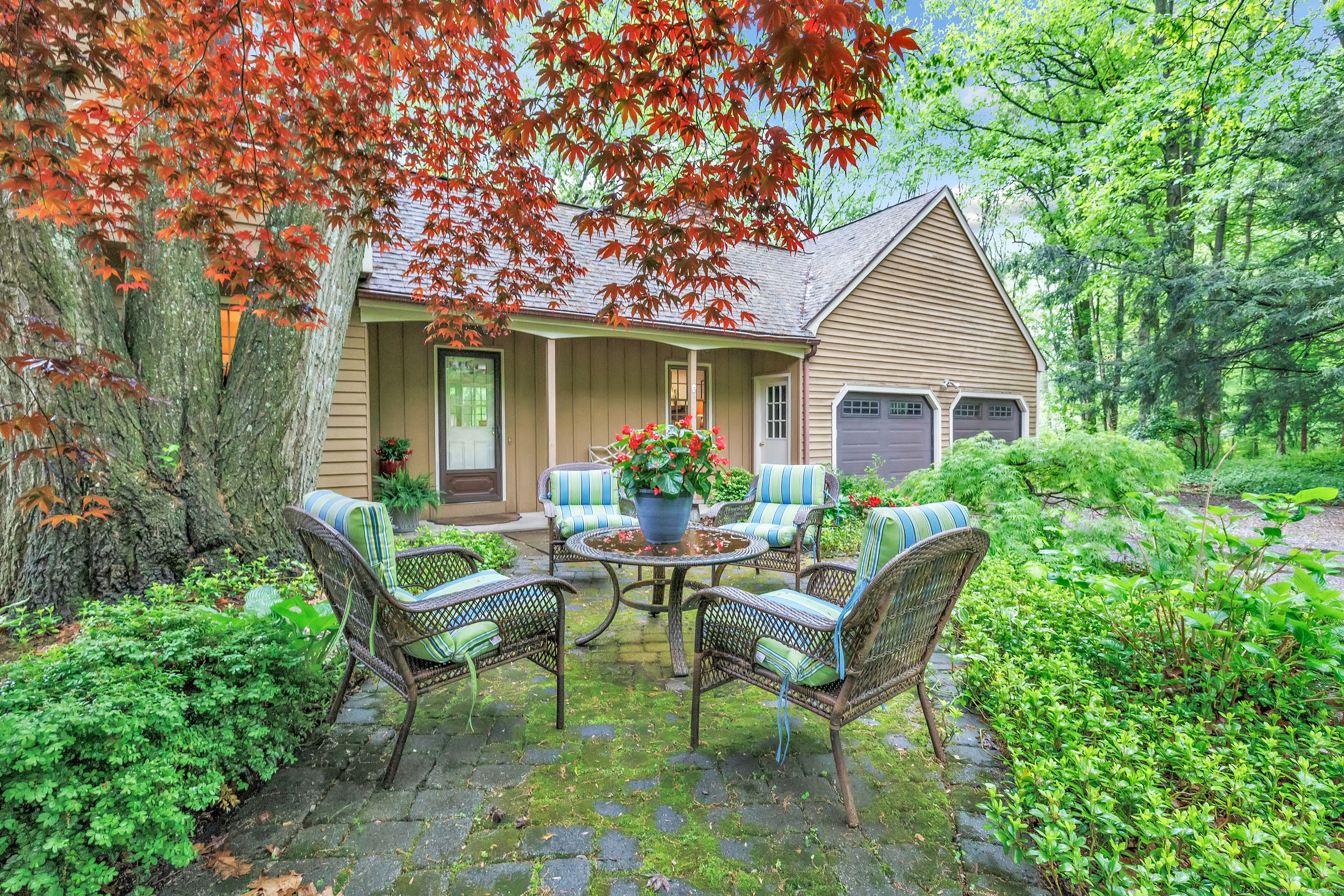 a view of a house with backyard sitting area and garden