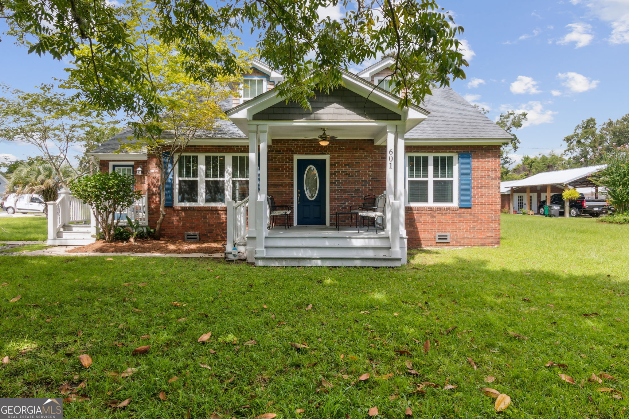 a front view of a house with a garden and porch