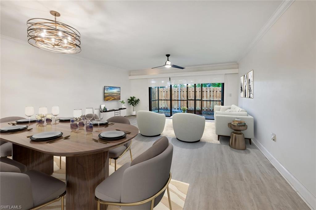 a view of a dining room with furniture a chandelier and wooden floor