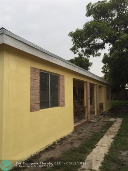 a view of house with yard