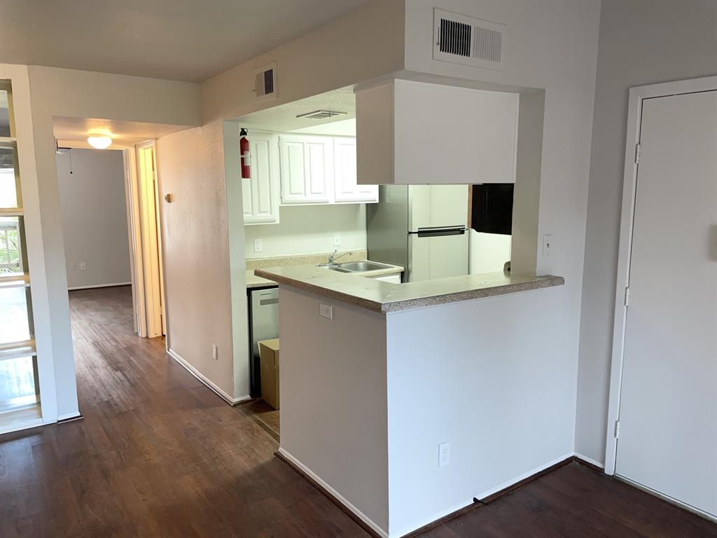 a view of kitchen with wooden floor and window