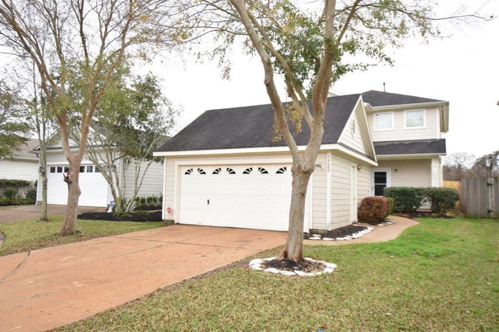 a view of a house with a yard and garage