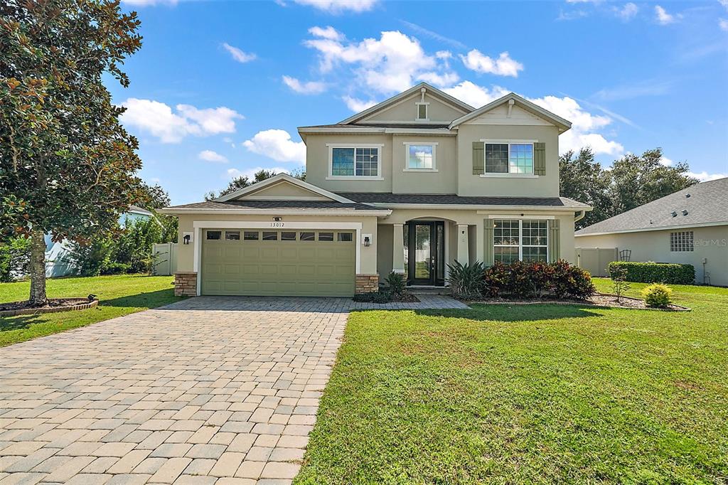 a front view of a house with a yard