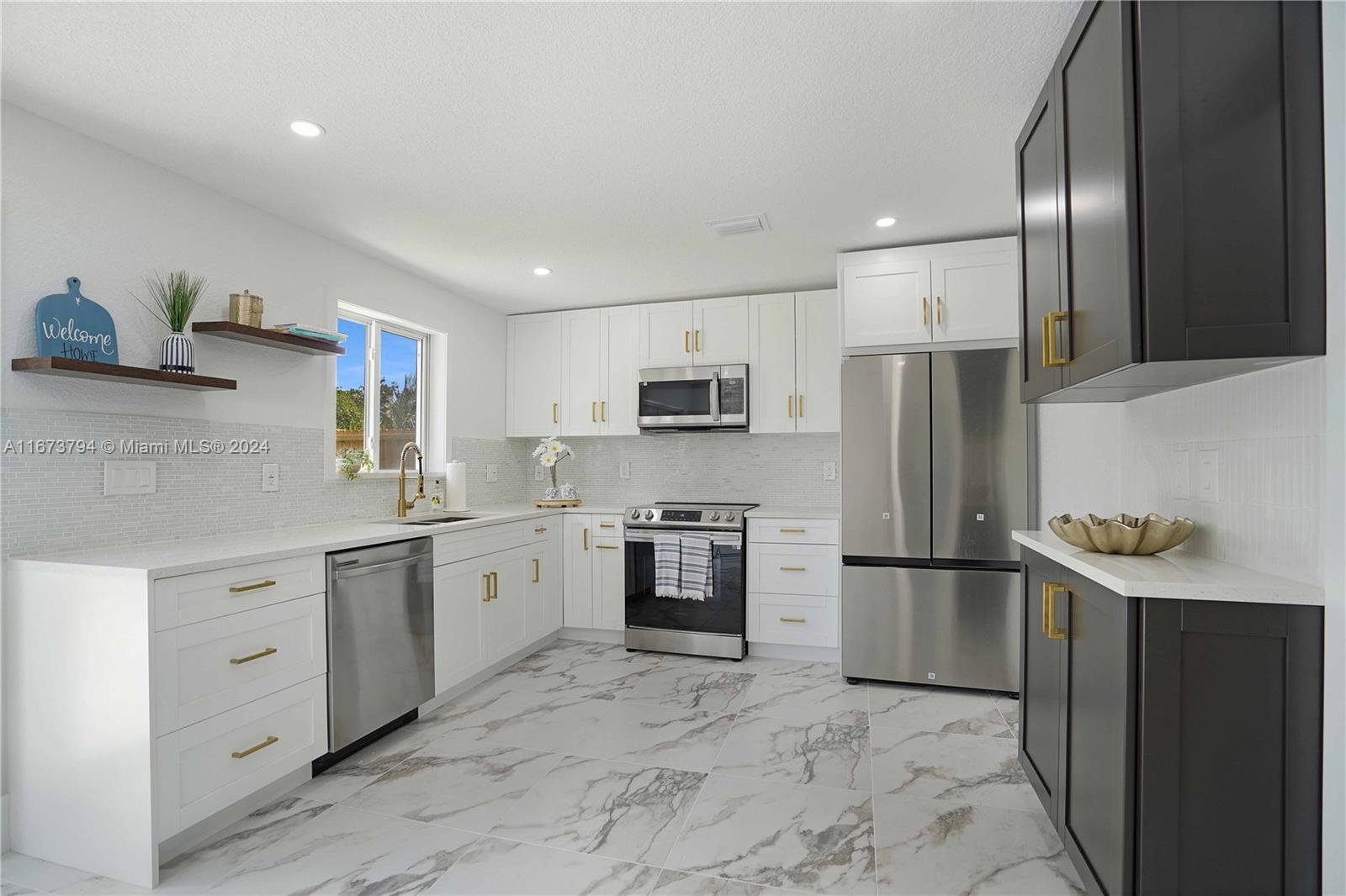 a kitchen with stainless steel appliances granite countertop a refrigerator sink and stove