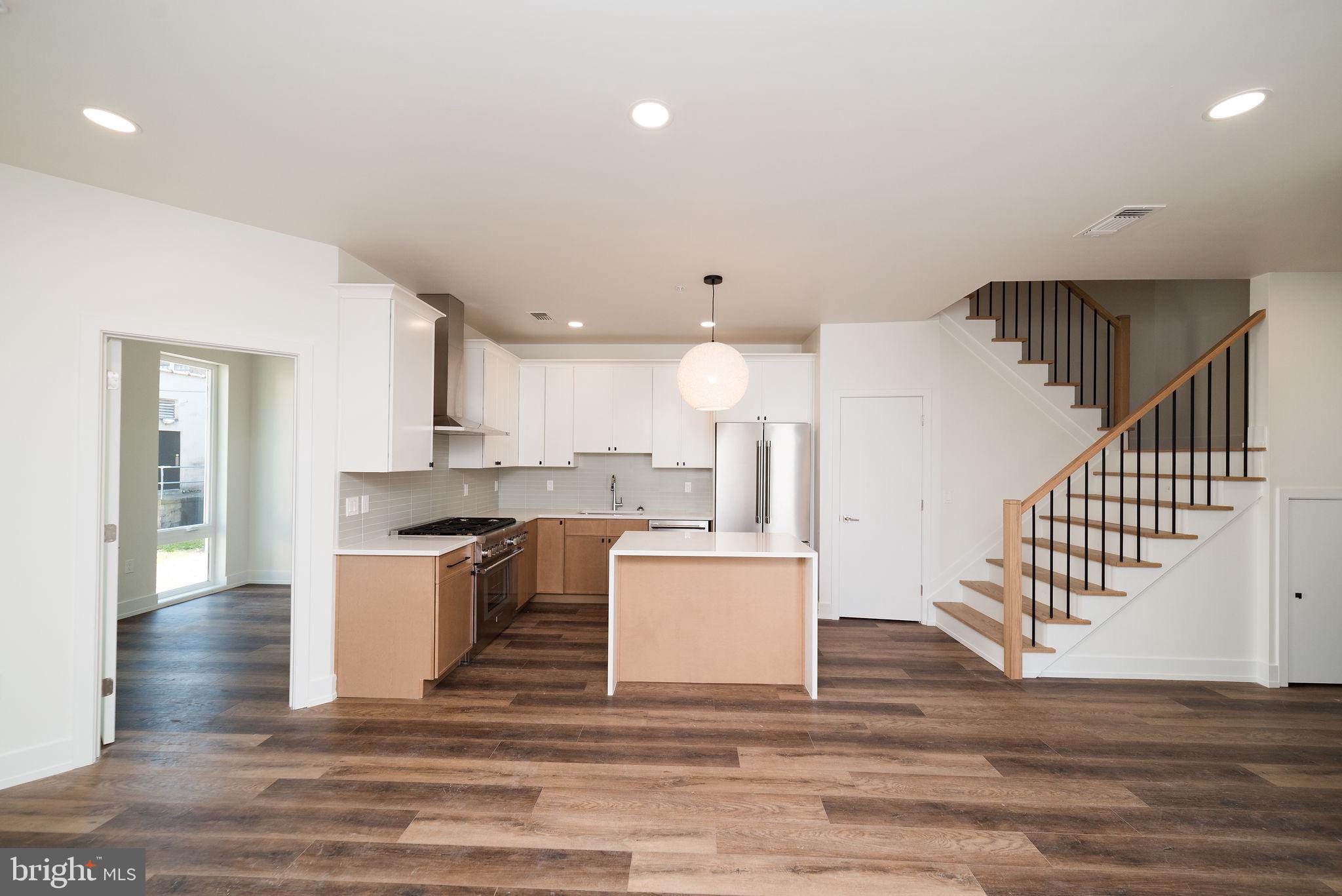 a view of kitchen with wooden floor and electronic appliances