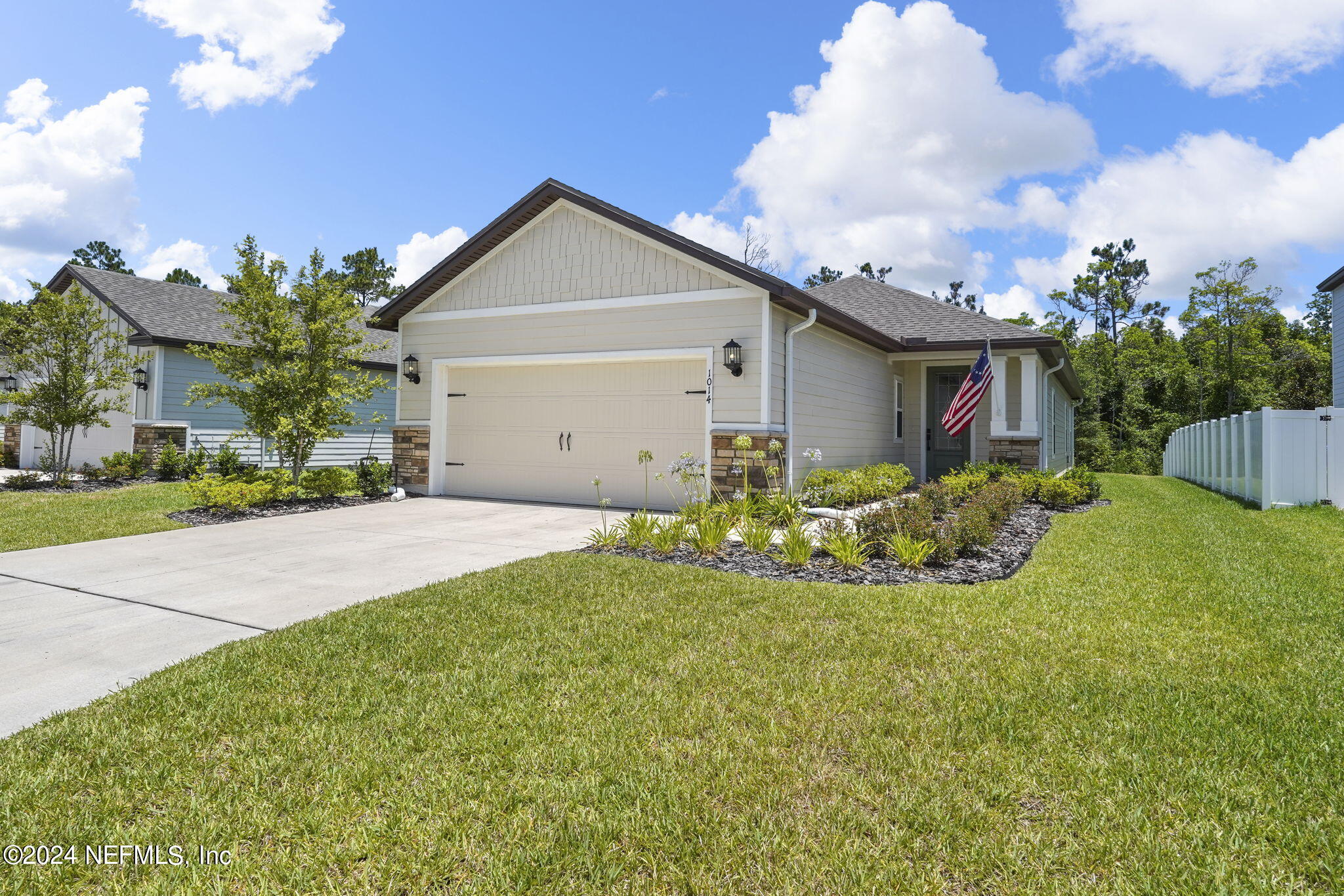 a front view of a house with garden