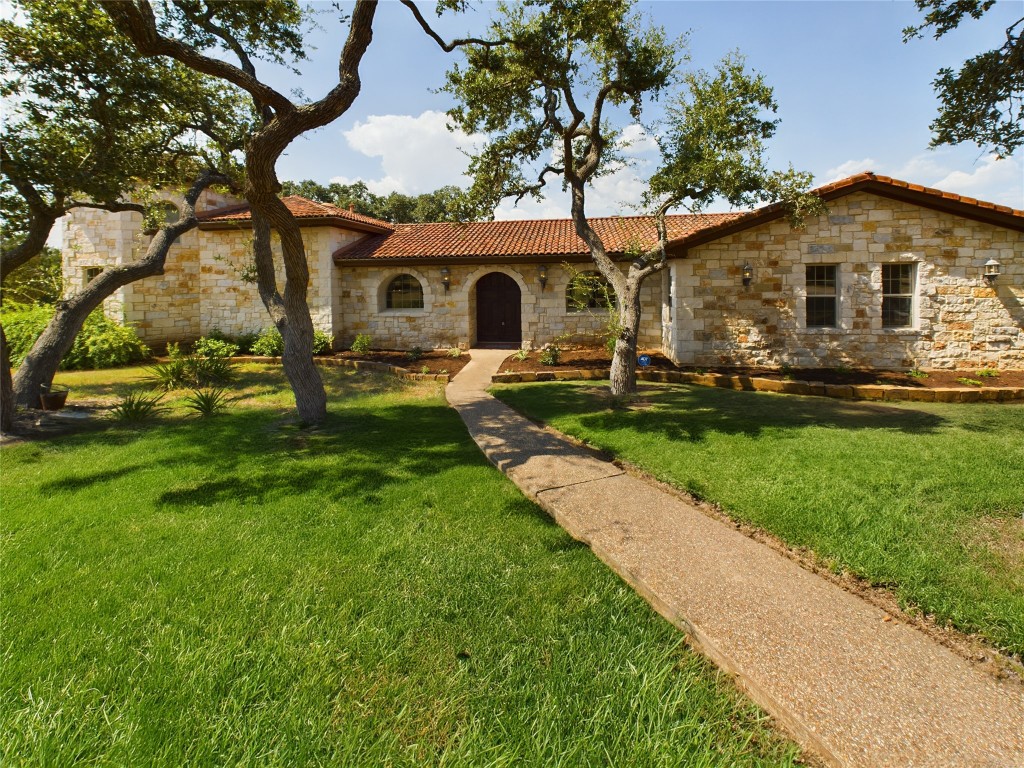 a front view of house with yard and green space