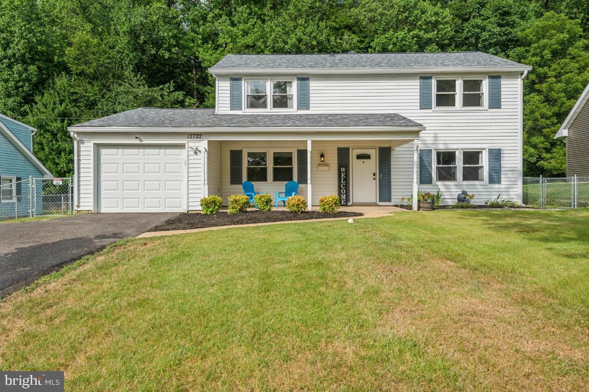 a front view of house with yard outdoor seating and barbeque oven