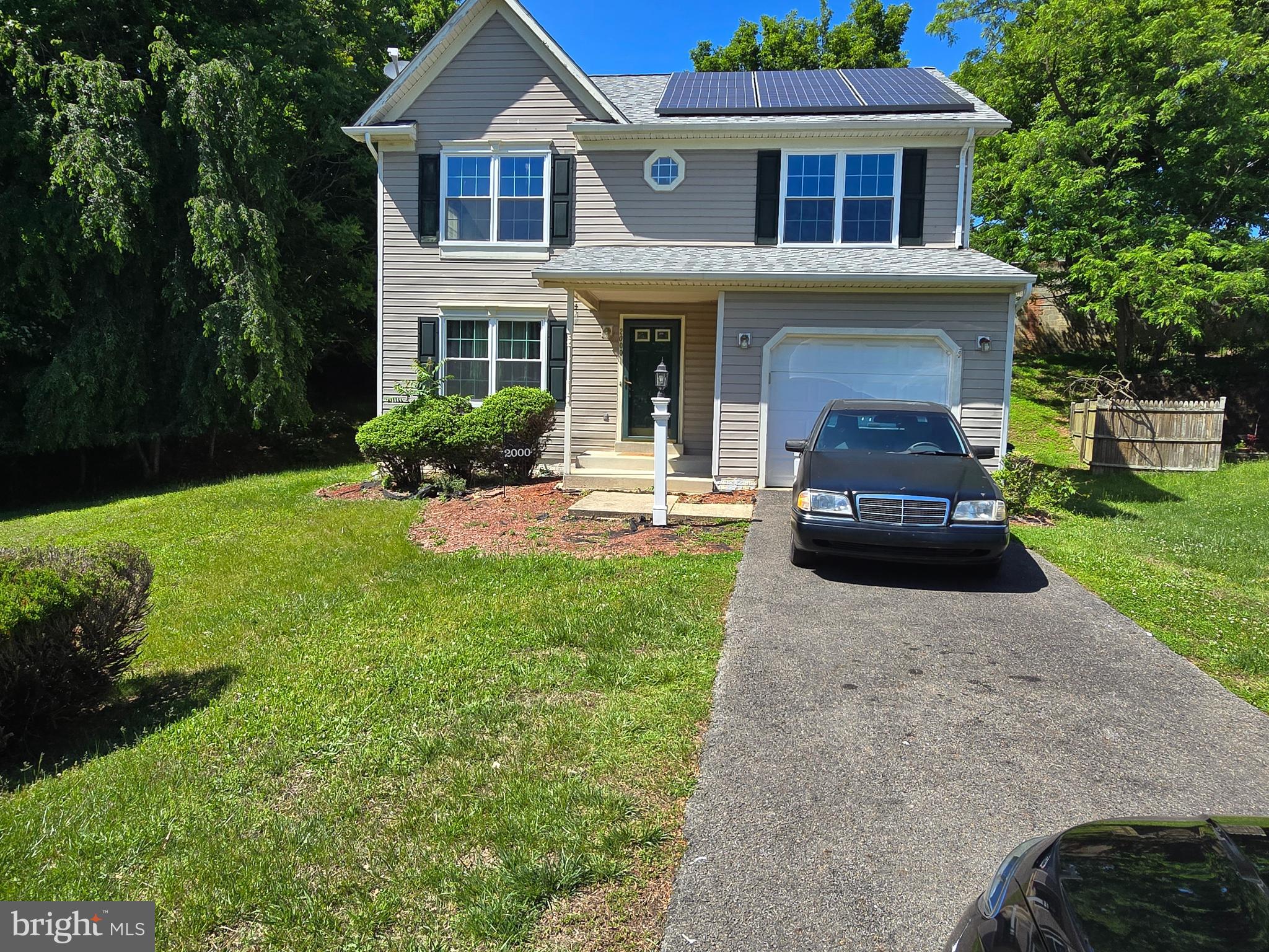 a front view of a house with a yard and porch