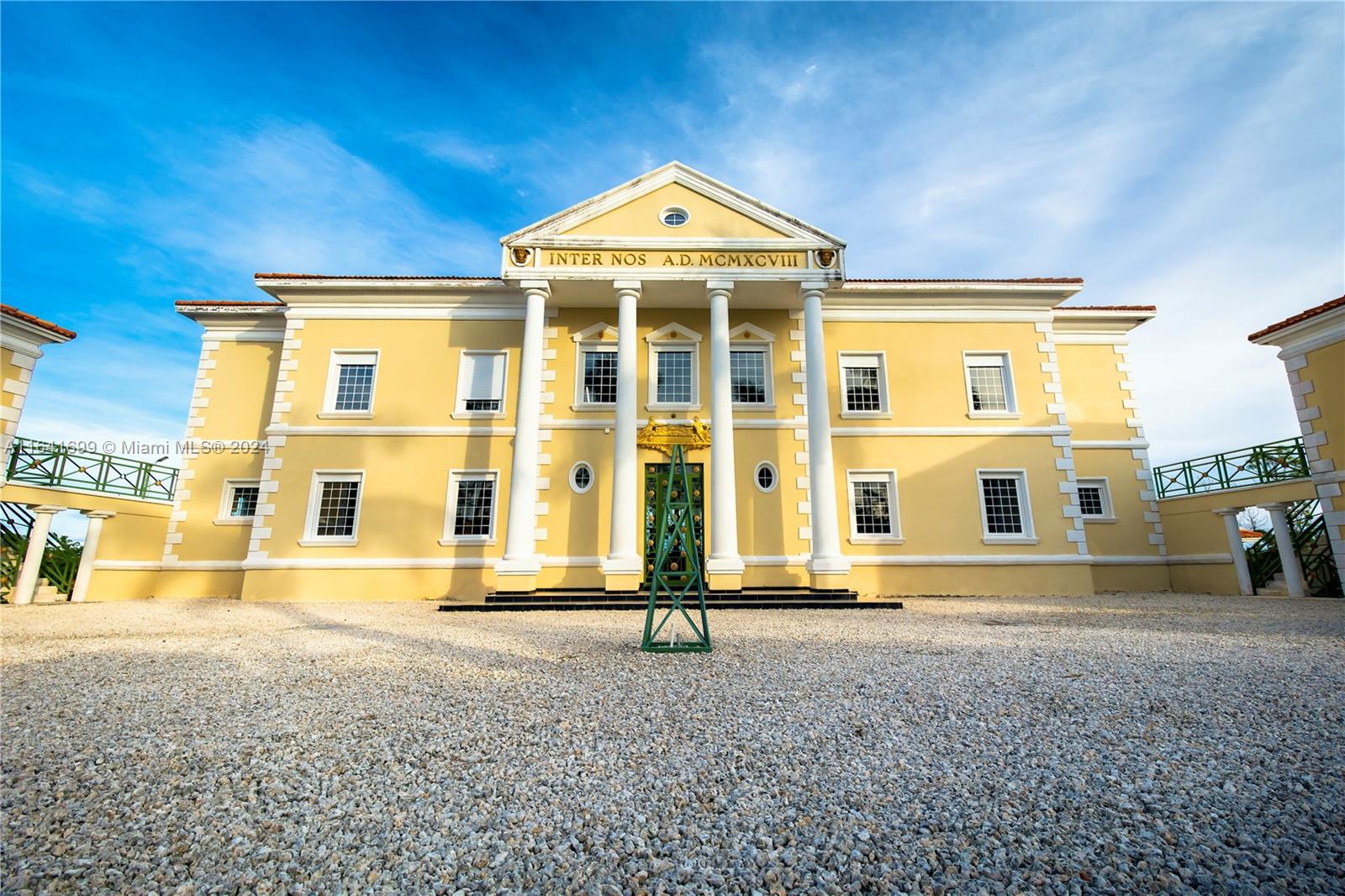 a front view of a building with a yard