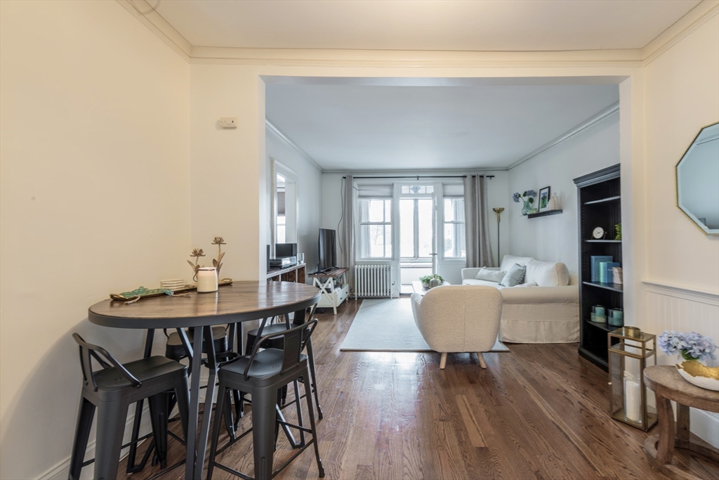 a dining room with furniture and wooden floor