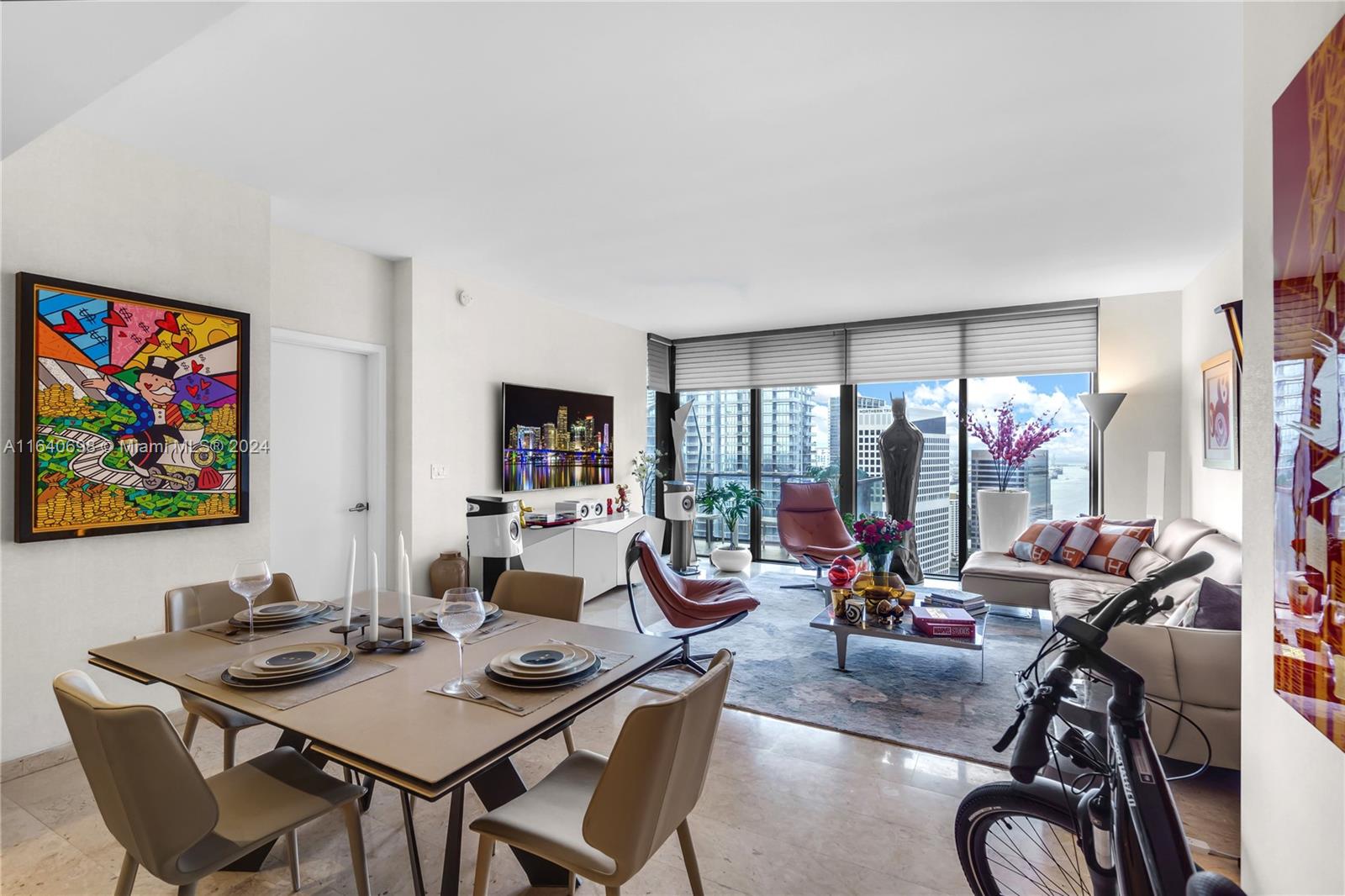 a living room with furniture a floor to ceiling window and a flat screen tv