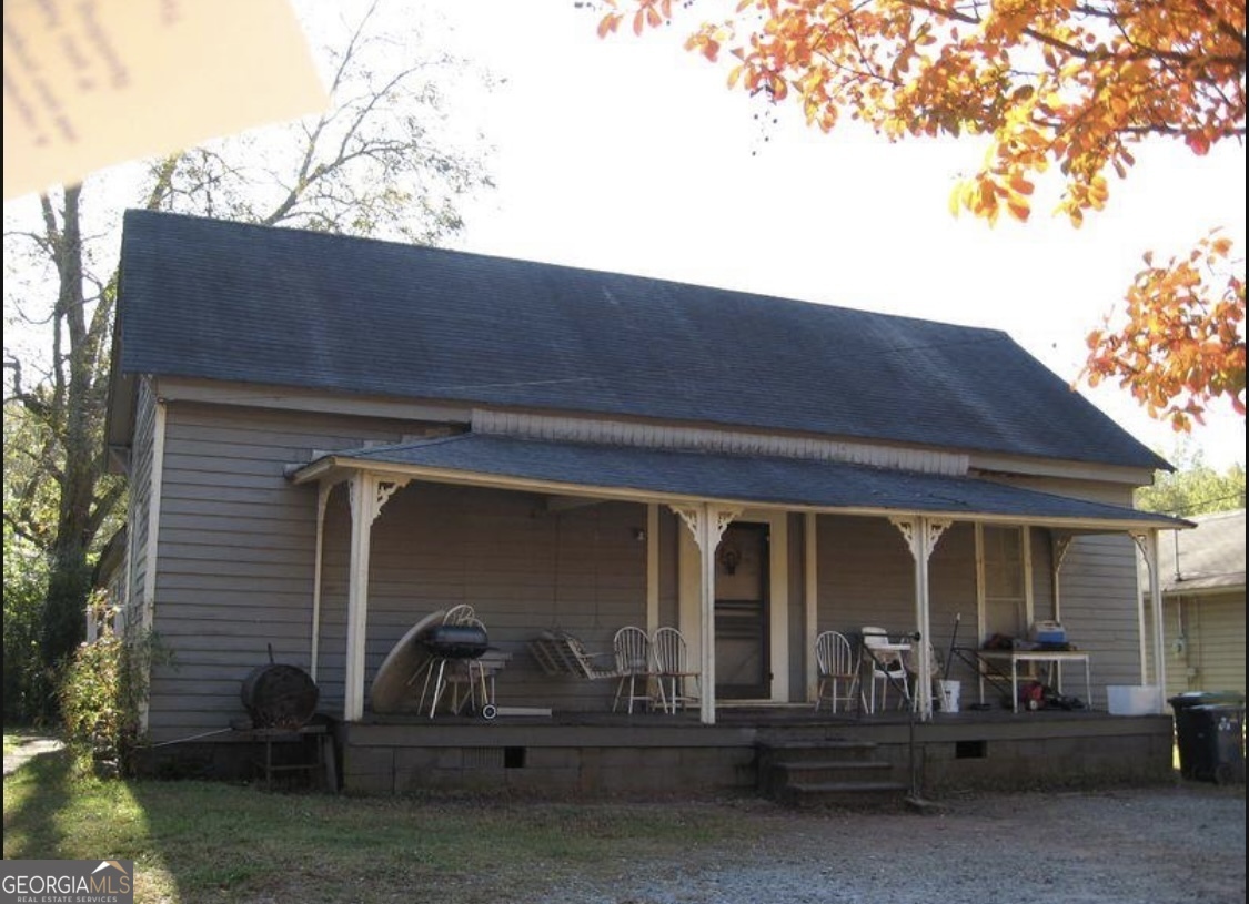 a view of house with outdoor space and porch