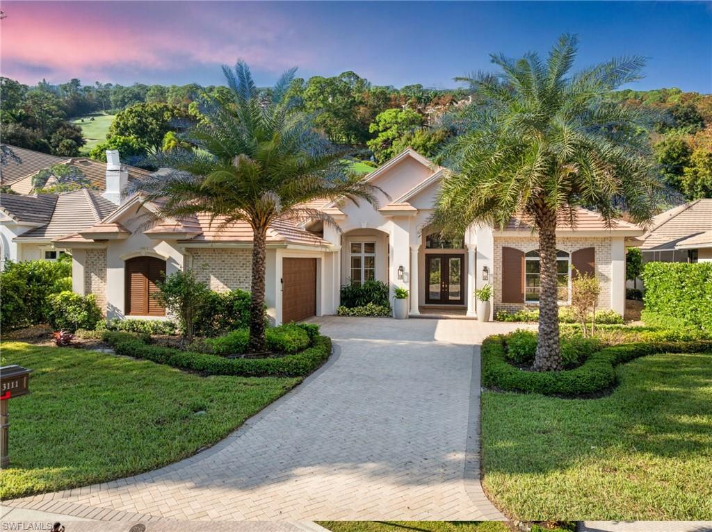 Mediterranean / spanish home with french doors, a garage, and a lawn