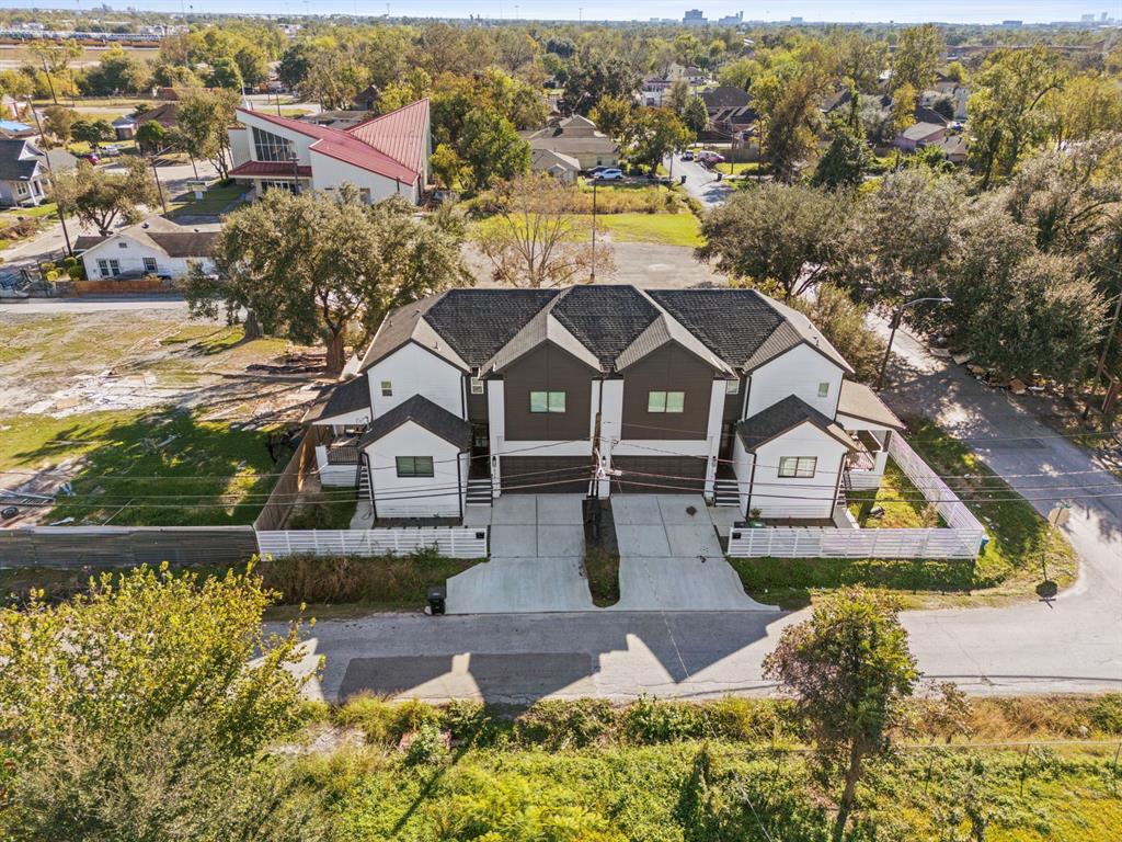 an aerial view of residential houses with outdoor space