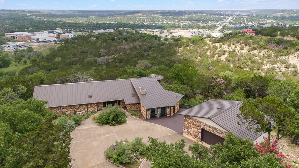 an aerial view of a house with a yard