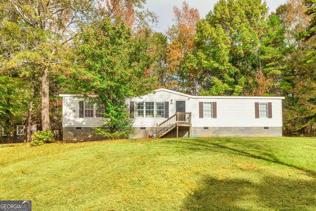 a front view of a house with a yard outdoor seating and garage