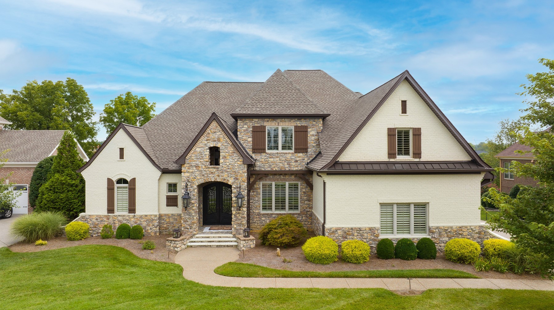 a front view of a house with a yard and garage