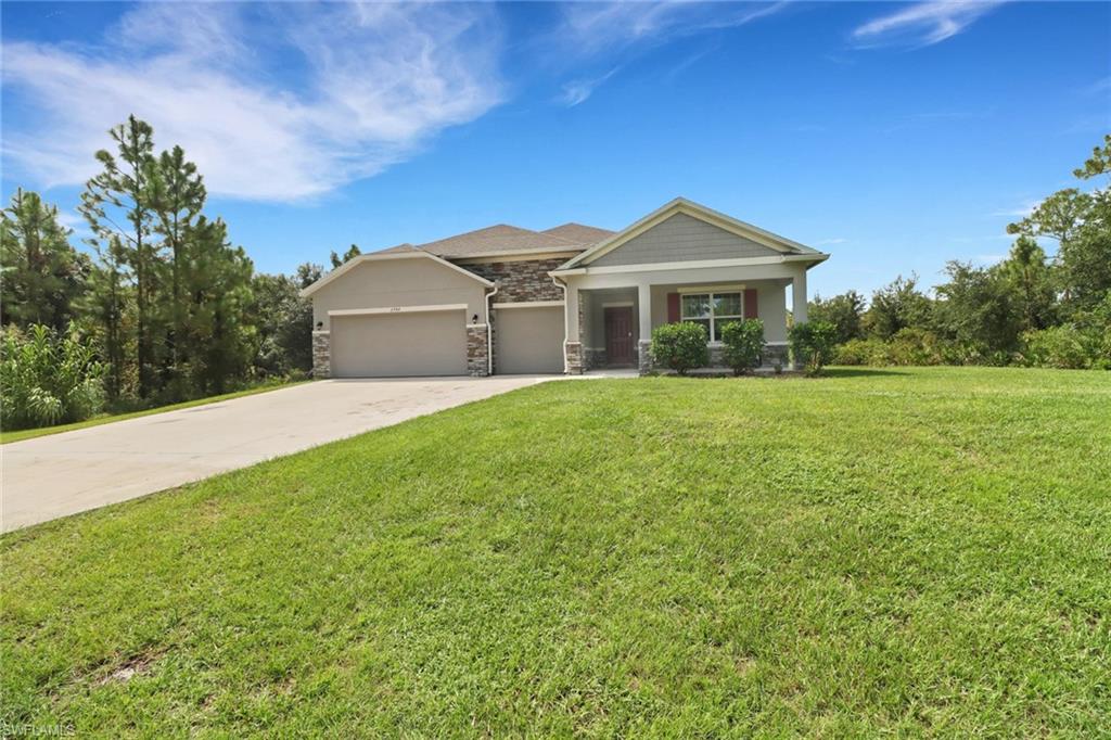 a front view of a house with yard and green space