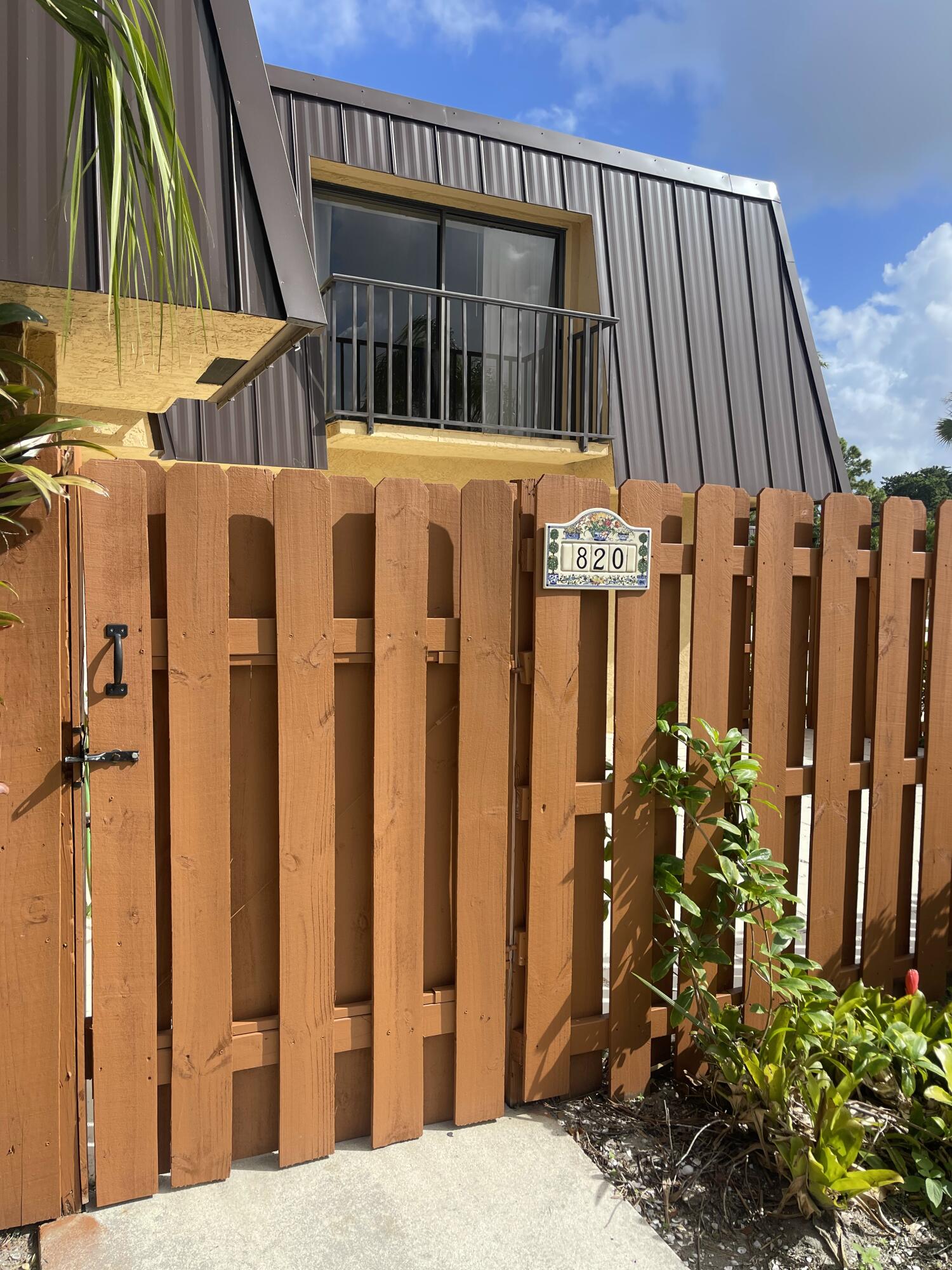 a view of a house with wooden fence