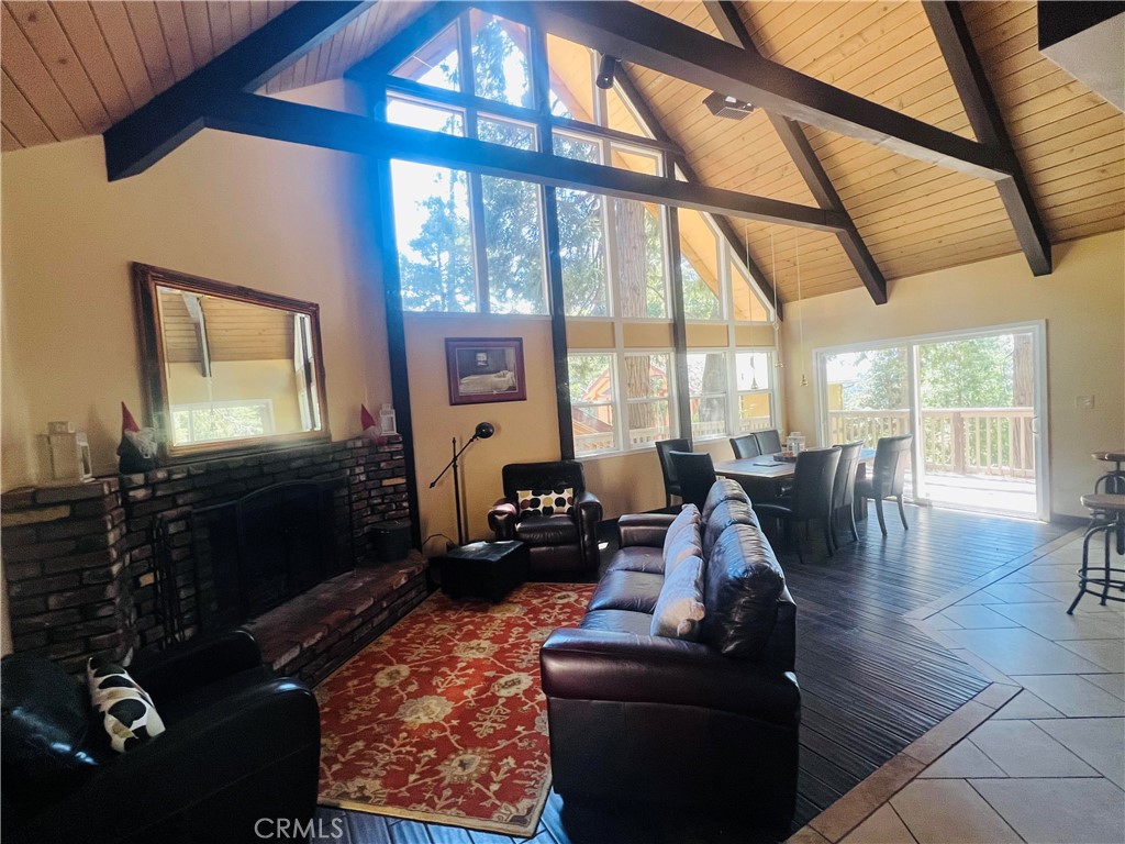 a living room with furniture fireplace and a large window