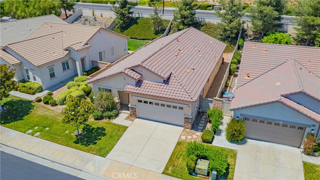 an aerial view of a house with a yard and potted plants