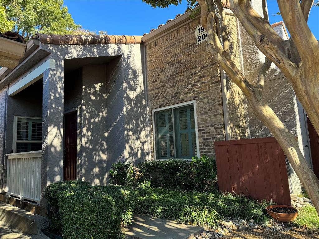 front view of a house with a tree